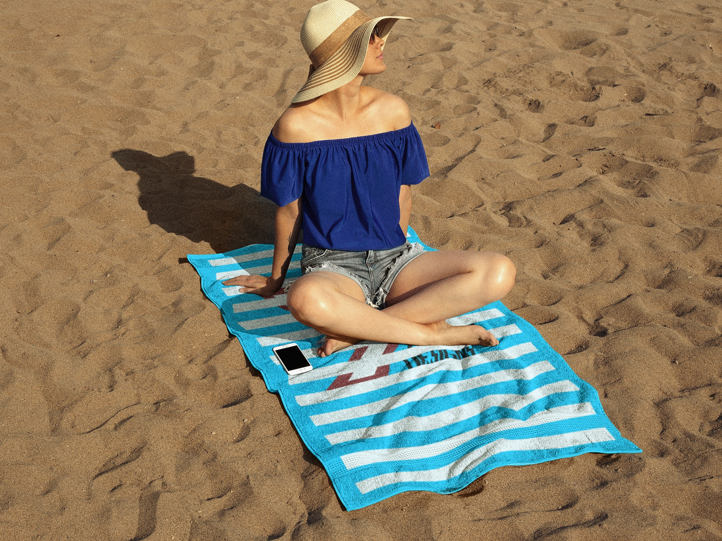 Striped beach towel featuring cyan and white cabana stripes with the 24/7 Unique Designs logo.